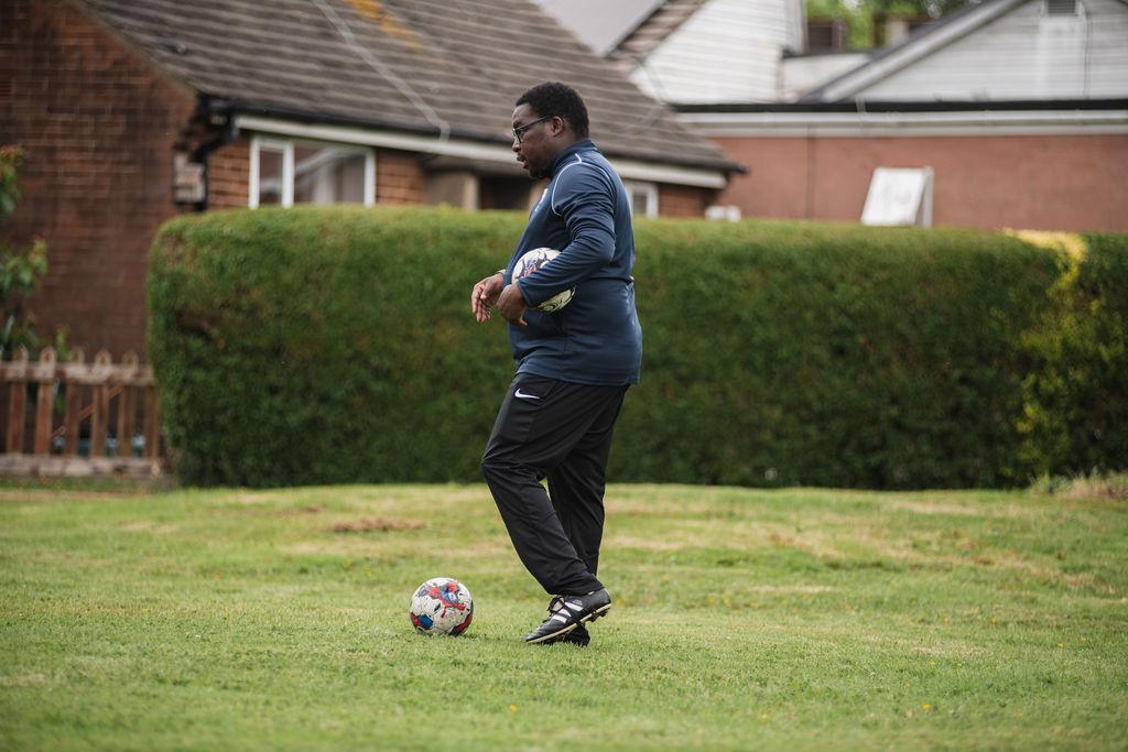 Coach Sagwati Malabi dribbling ball during training session