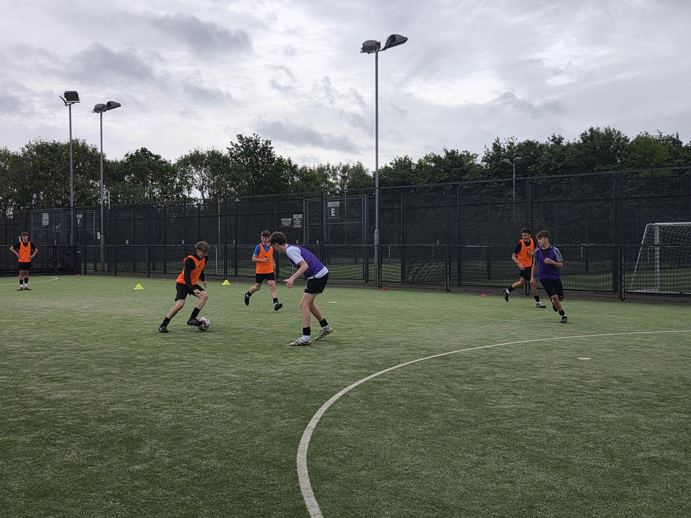 Agility and dribbling session under floodlights